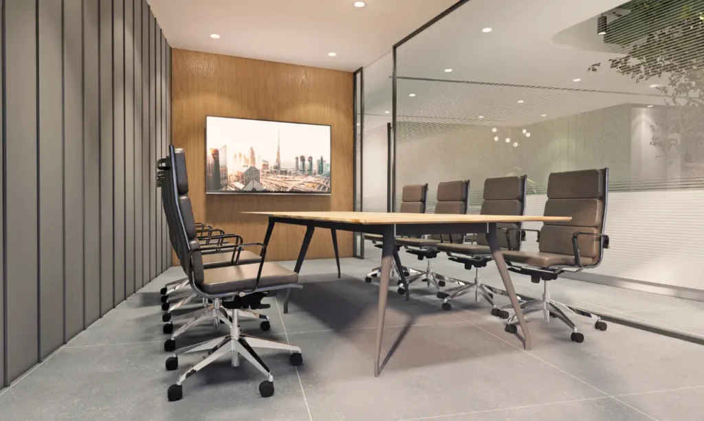 A conference room with a large screen and chairs.