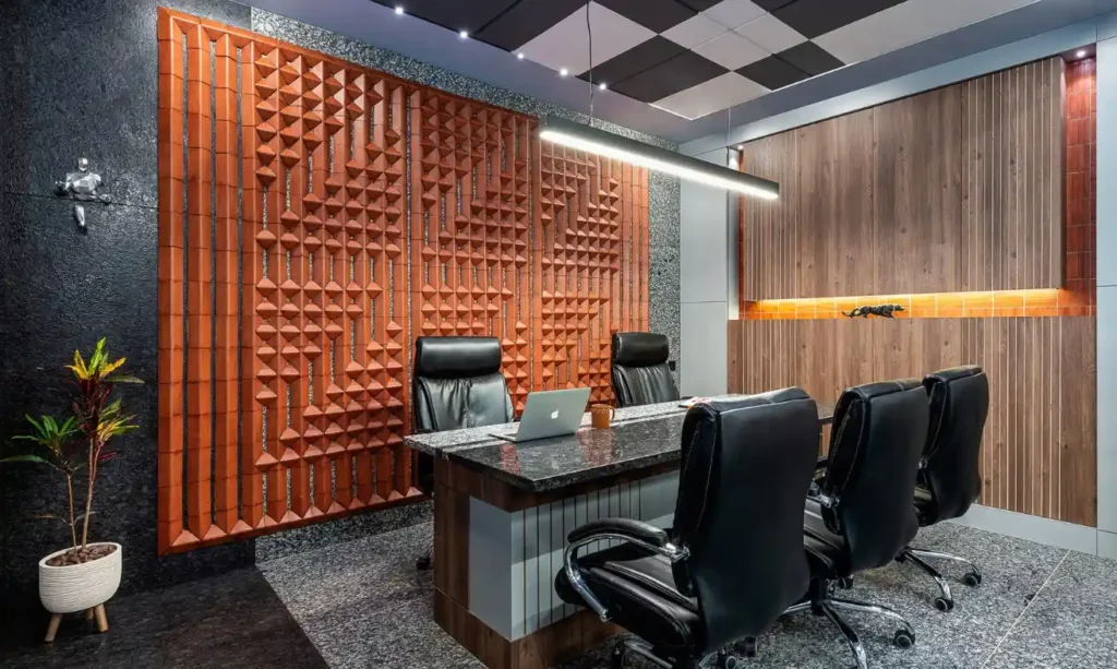 An office with a wooden wall and black chairs.