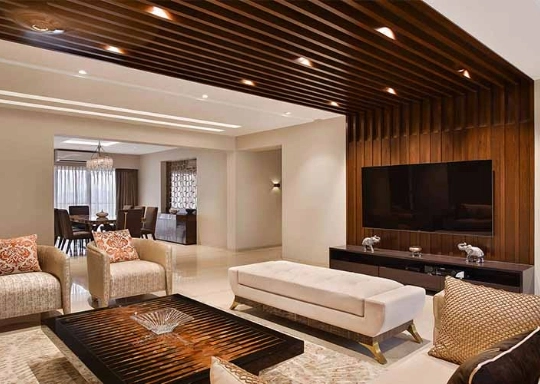 A cozy living room with wooden ceiling and furniture