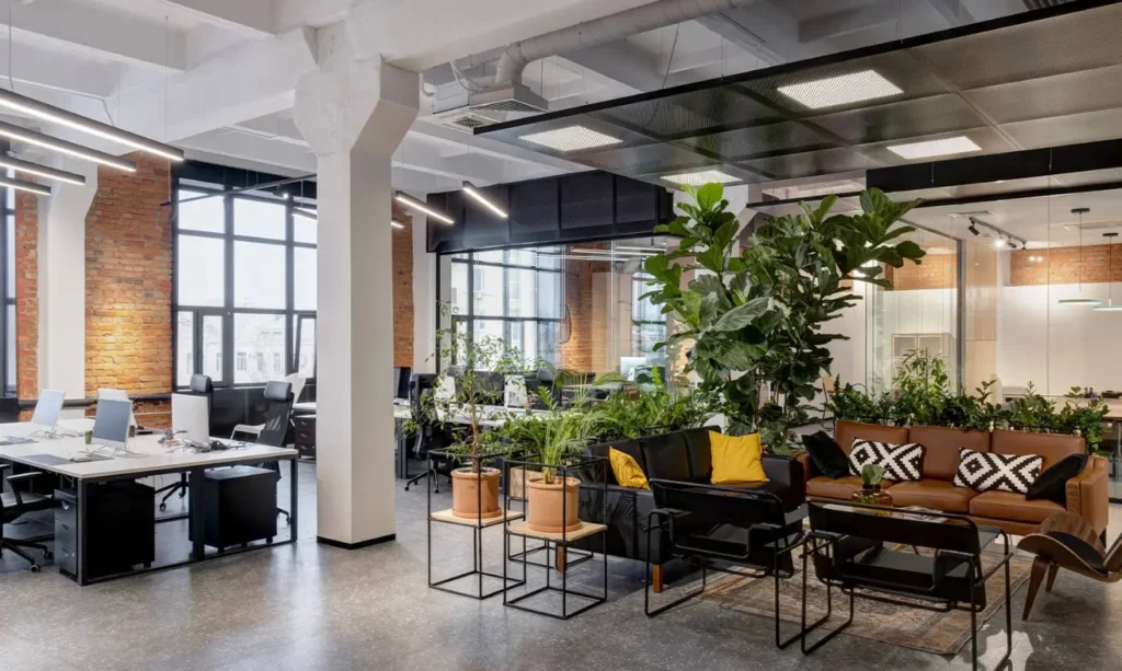 A modern open office space with lush green plants